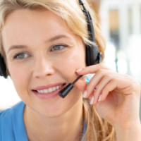 Female customer service executive talking on headset in a modern office